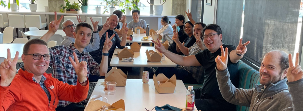 A group photo of new AI2 team members eating lunch together at AI2 headquarters.